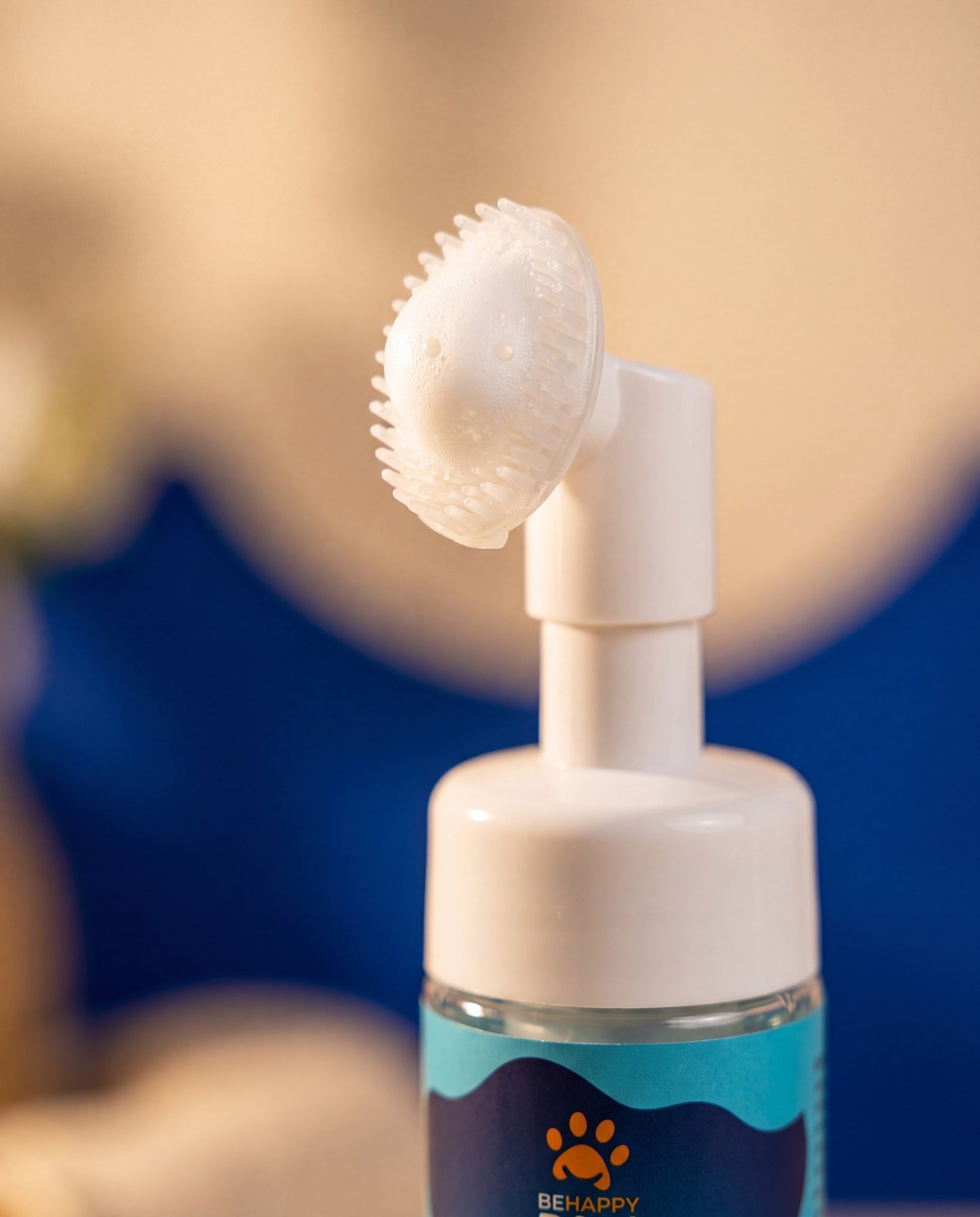 Macro detail of the Paw Foam pump and integrated silicone brush with a dab of foam